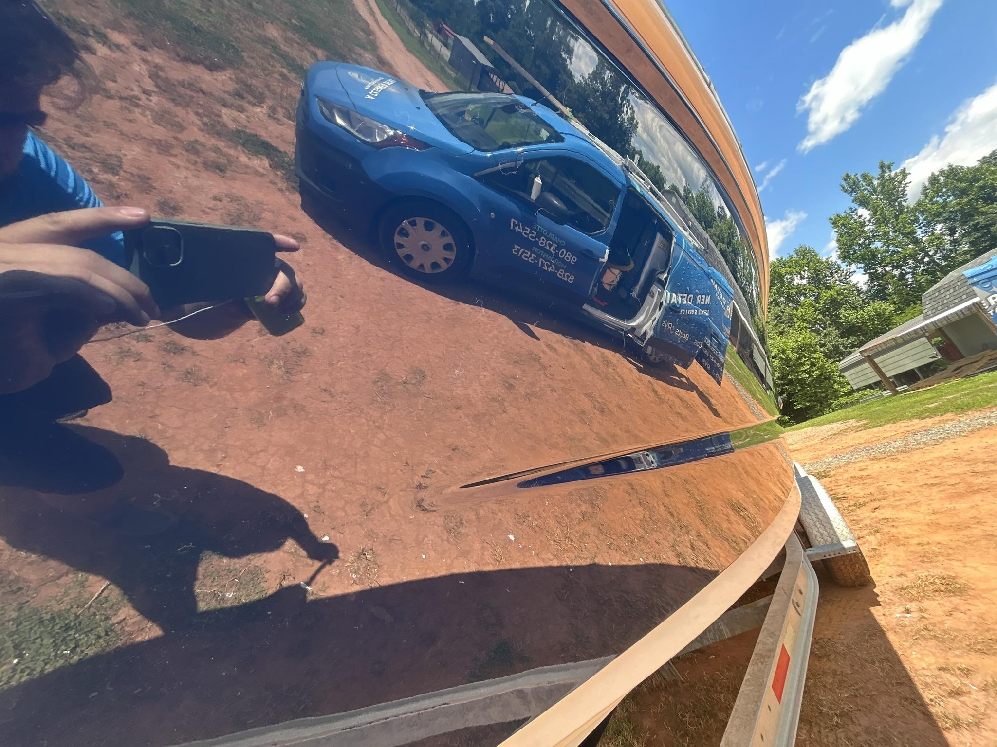 Service van reflected in polished vehicle body